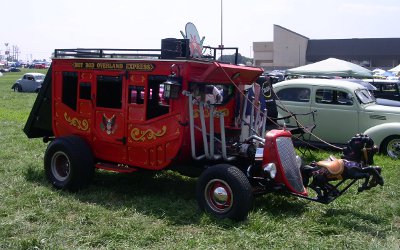 [Car made to look like stagecoach with merry-go-round horses in front.]